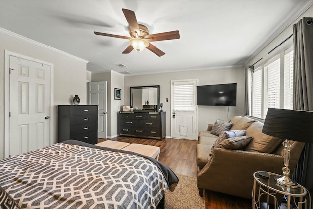 bedroom with crown molding, visible vents, a ceiling fan, and wood finished floors
