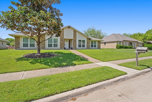 view of front of property with a front lawn and brick siding