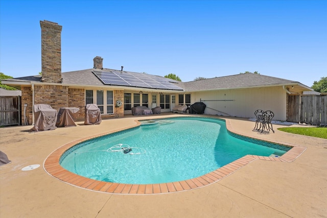 view of swimming pool featuring fence, a fenced in pool, and a patio