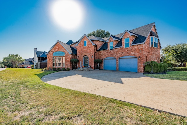 101 Reliance Ct, Rockwall, TX 75032 - traditional-style house with brick siding, driveway, an attached garage, and a front lawn