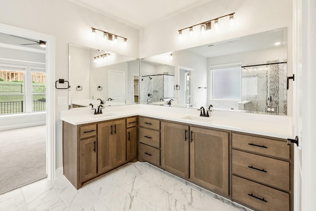 bathroom featuring a marble finish shower, plenty of natural light, and marble finish floors