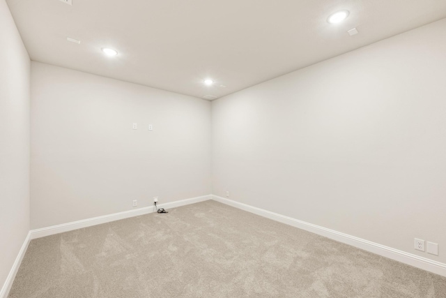 unfurnished room featuring carpet flooring, baseboards, and recessed lighting