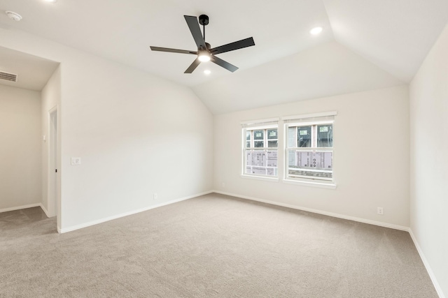 spare room featuring carpet flooring, ceiling fan, vaulted ceiling, recessed lighting, and baseboards