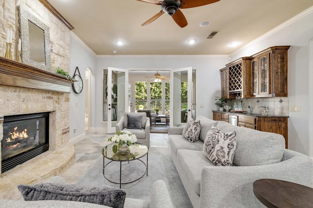 1121 Crystal Falls Dr, Prosper, TX 75078 - living area with ceiling fan, bar, crown molding, a fireplace, and recessed lighting