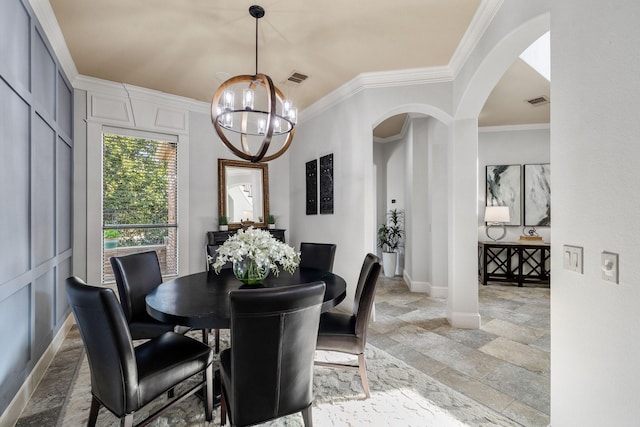 1121 Crystal Falls Dr, Prosper, TX 75078 - dining space featuring a chandelier, stone tile flooring, arched walkways, crown molding, and baseboards
