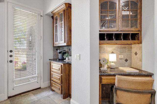 1121 Crystal Falls Dr, Prosper, TX 75078 - bar area with tasteful backsplash, built in desk, and baseboards