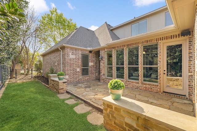 1121 Crystal Falls Dr, Prosper, TX 75078 - rear view of property featuring a shingled roof, brick siding, and a patio