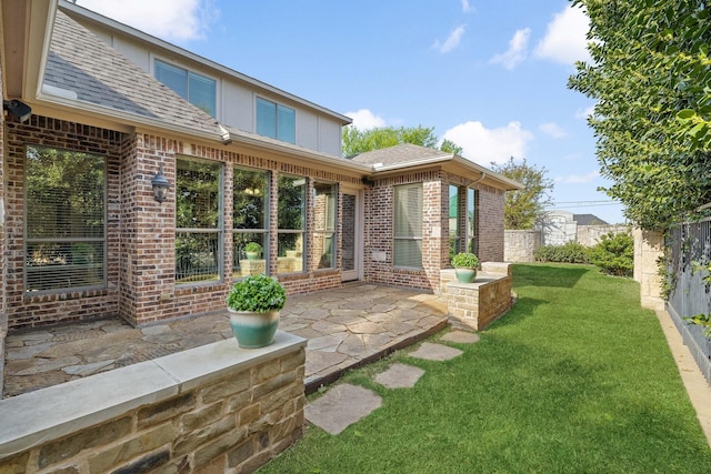 1121 Crystal Falls Dr, Prosper, TX 75078 - back of property featuring roof with shingles, brick siding, and a patio