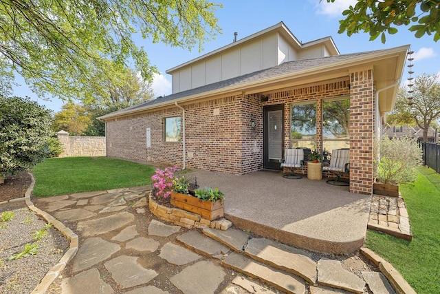 1121 Crystal Falls Dr, Prosper, TX 75078 - rear view of house featuring brick siding, a patio area, and board and batten siding