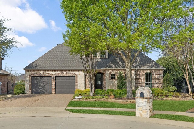 1121 Crystal Falls Dr, Prosper, TX 75078 - view of front of home featuring a garage, brick siding, driveway, and a shingled roof