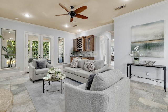 1121 Crystal Falls Dr, Prosper, TX 75078 - living room with arched walkways, ornamental molding, french doors, ceiling fan, and recessed lighting