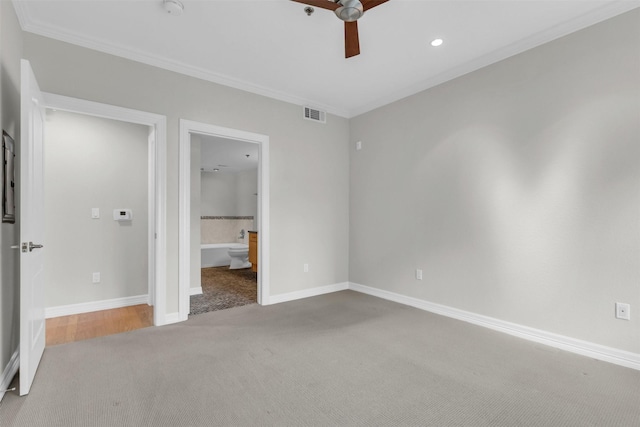 unfurnished bedroom with baseboards, carpet floors, visible vents, and crown molding