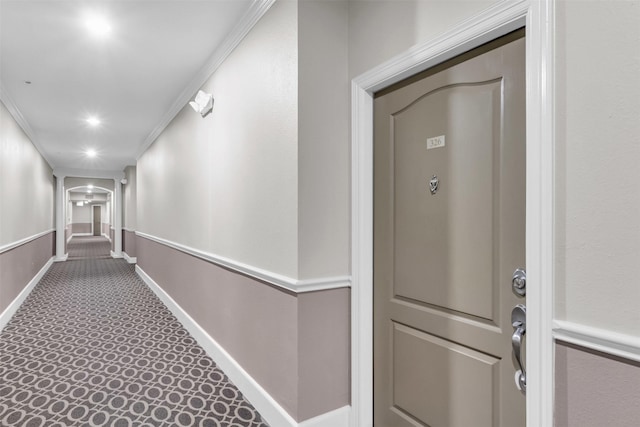 corridor with baseboards, carpet floors, ornamental molding, and recessed lighting