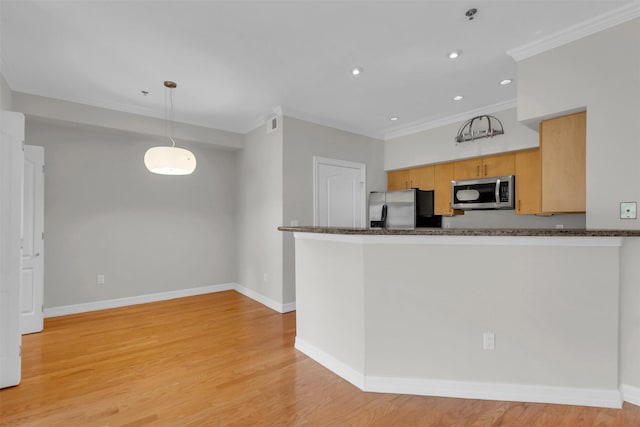 kitchen featuring baseboards, ornamental molding, stainless steel appliances, and light wood-type flooring