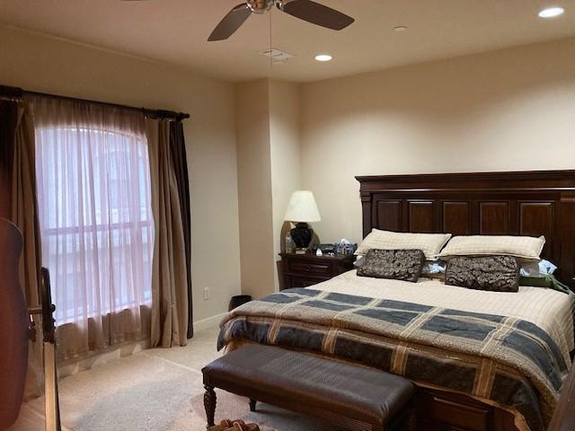 bedroom with baseboards, light carpet, a ceiling fan, and recessed lighting