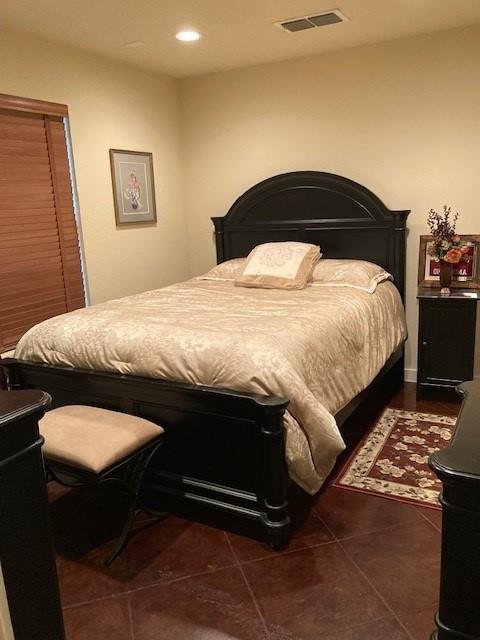 bedroom featuring dark tile patterned floors, visible vents, and recessed lighting