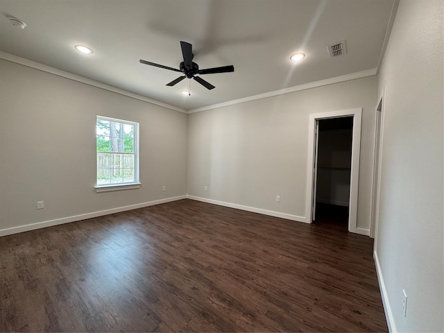 unfurnished room featuring ornamental molding, dark wood-style floors, ceiling fan, and visible vents