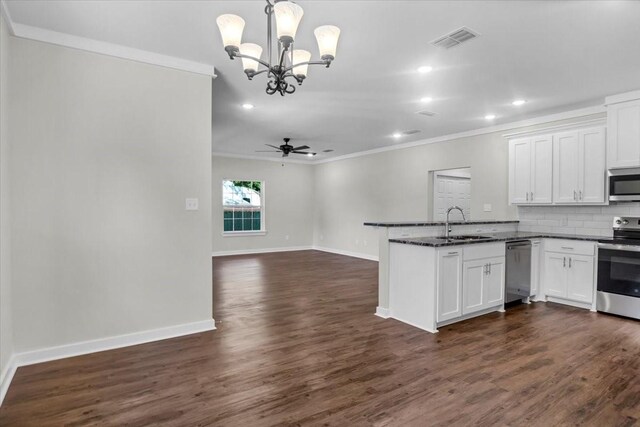 2377 Ridgley Dr, Flint, TX 75762 - kitchen with stainless steel appliances, a sink, crown molding, a chandelier, and tasteful backsplash
