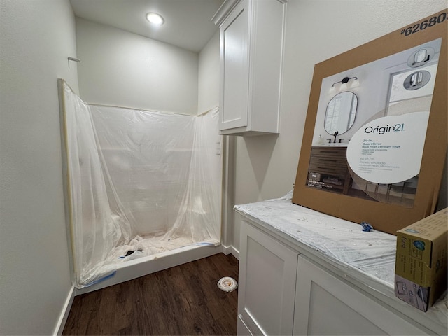 bathroom featuring baseboards and wood finished floors