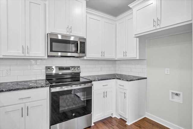2377 Ridgley Dr, Flint, TX 75762 - kitchen with stainless steel appliances, dark stone counters, dark wood-style flooring, tasteful backsplash, and baseboards