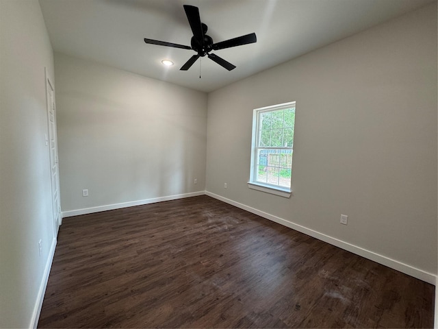 spare room featuring baseboards, a ceiling fan, dark wood-type flooring, and recessed lighting