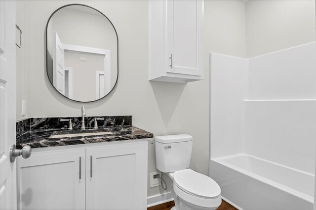 2377 Ridgley Dr, Flint, TX 75762 - bathroom with toilet, vanity, and wood finished floors