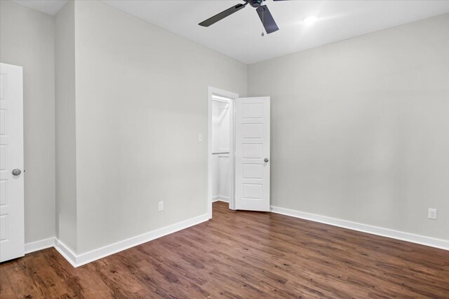 2377 Ridgley Dr, Flint, TX 75762 - unfurnished bedroom with dark wood-style flooring, baseboards, and a ceiling fan