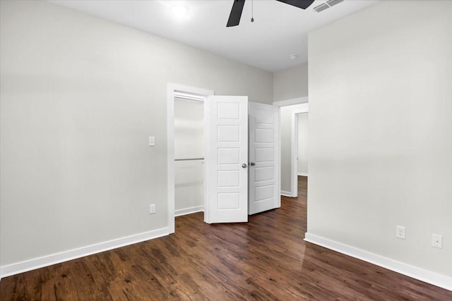 2377 Ridgley Dr, Flint, TX 75762 - unfurnished bedroom with baseboards, dark wood finished floors, ceiling fan, and a closet