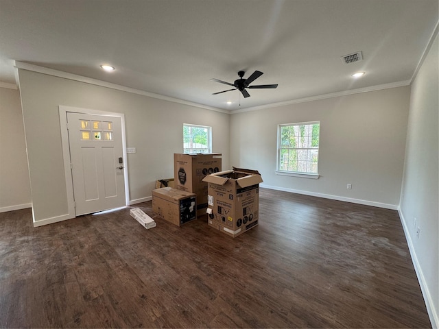 interior space featuring crown molding, baseboards, visible vents, and a wealth of natural light