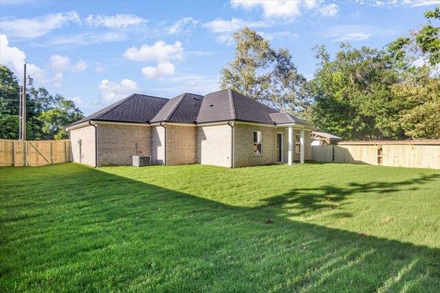 2377 Ridgley Dr, Flint, TX 75762 - rear view of property with central air condition unit, brick siding, and roof with shingles