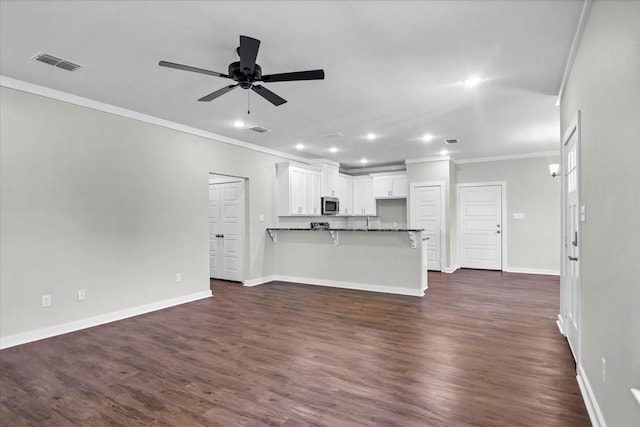 2377 Ridgley Dr, Flint, TX 75762 - unfurnished living room with ornamental molding, recessed lighting, ceiling fan, baseboards, and dark wood-style flooring