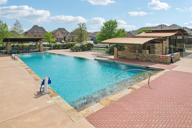 1909 Old Charm Trl, Wylie, TX 75098 - pool with a patio, a residential view, and fence