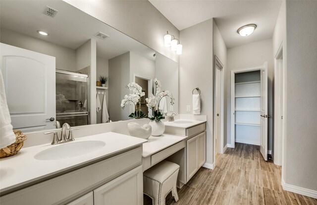 1814 Brindle St, Northlake, TX 76247 - full bath with a sink, a shower stall, wood finished floors, visible vents, and double vanity