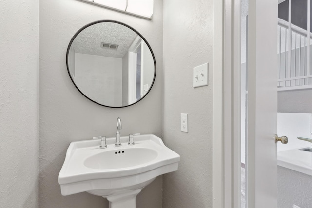 3931 Roma Ct, Rockwall, TX 75087 - bathroom featuring a sink and a textured wall