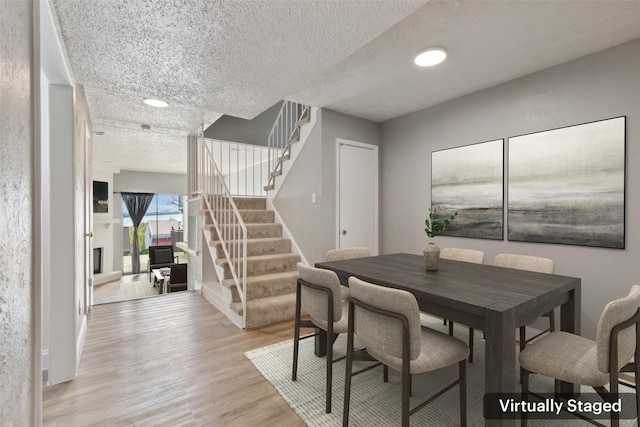 3931 Roma Ct, Rockwall, TX 75087 - dining space with stairway, light wood-style floors, a textured ceiling, baseboards, and recessed lighting