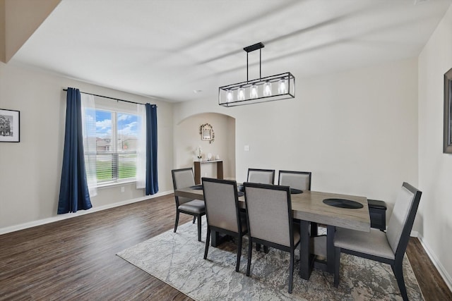 1616 Mackinac Dr, Crowley, TX 76036 - dining area featuring wood finished floors, baseboards, and arched walkways