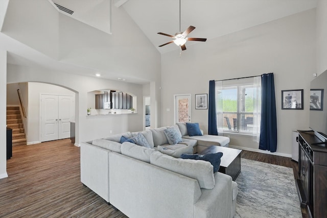 1616 Mackinac Dr, Crowley, TX 76036 - living area featuring ceiling fan, high vaulted ceiling, dark wood-type flooring, arched walkways, and stairway