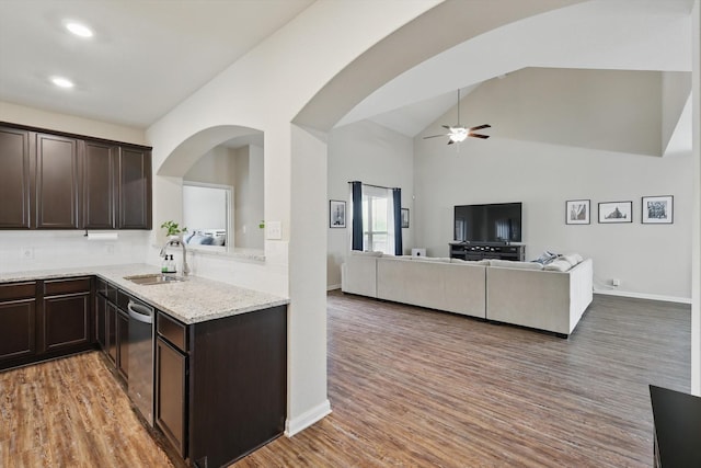 1616 Mackinac Dr, Crowley, TX 76036 - kitchen with dark brown cabinetry, dishwasher, arched walkways, and a sink