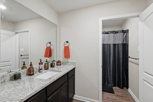 1616 Mackinac Dr, Crowley, TX 76036 - full bath featuring vanity, a shower with shower curtain, baseboards, and wood finished floors