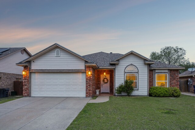 328 Peachtree Ln, Princeton, TX 75407 - view of front of house featuring driveway, an attached garage, brick siding, a yard, and a shingled roof