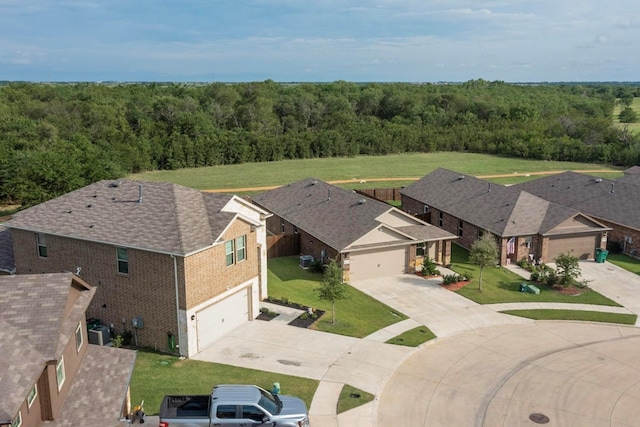 drone / aerial view featuring a wooded view