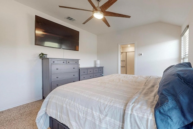carpeted bedroom featuring vaulted ceiling, baseboards, ceiling fan, visible vents, and ensuite bathroom