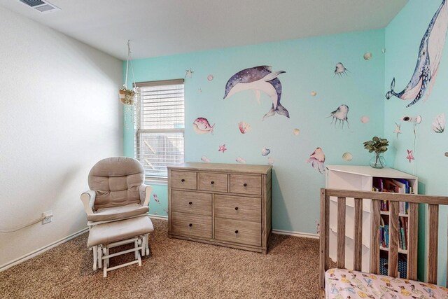 bedroom with baseboards, visible vents, a crib, and light colored carpet