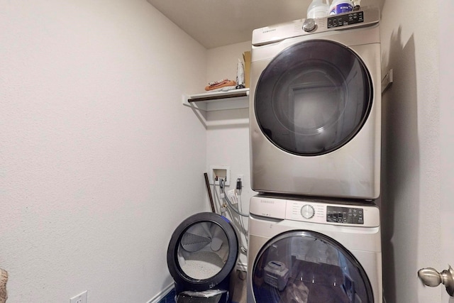 laundry room with stacked washer and dryer and laundry area
