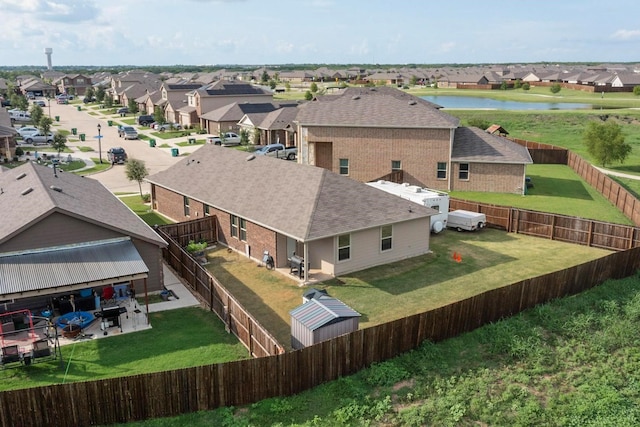 birds eye view of property featuring a residential view and a water view
