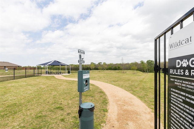 view of community with a lawn, a gazebo, and fence
