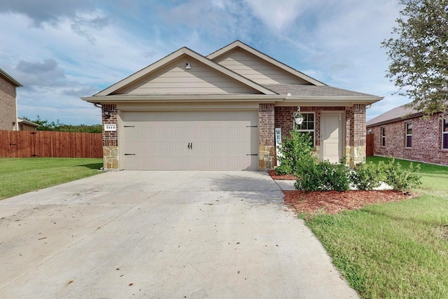 view of front of property featuring a front yard, stone siding, concrete driveway, fence, and a garage