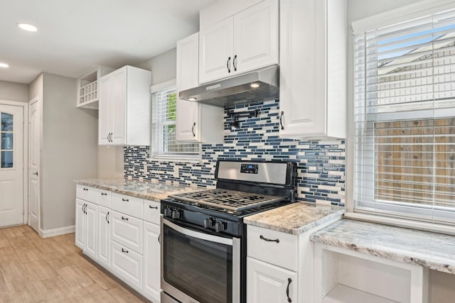 kitchen featuring stainless steel range with gas cooktop, under cabinet range hood, white cabinetry, backsplash, and recessed lighting