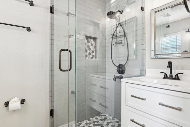 full bath with a stall shower and vanity