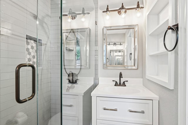 bathroom with a shower stall and vanity